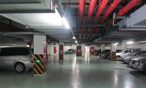 Parking garage with 8 parked cars at International Service Apartments