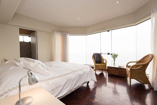 Spacious bedroom with daylight and a stunning view of the city