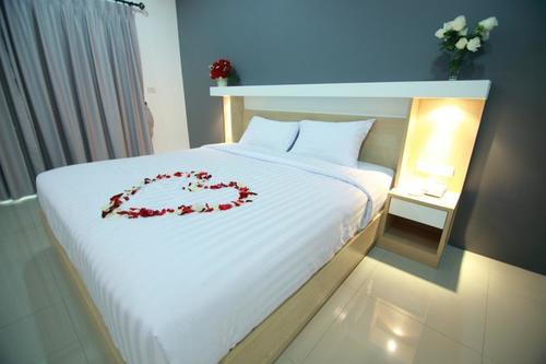 Comfortable bed covered in roses