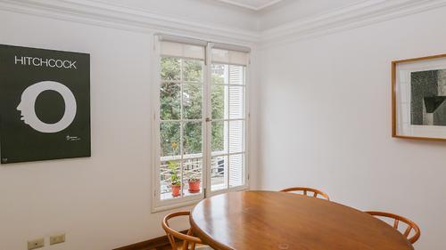 Large dining table by the window with 4 chairs