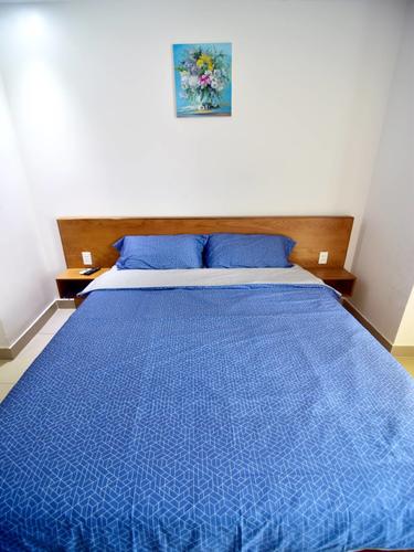 Comfortable bed with a blue bedding set and pillows