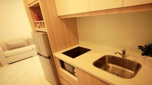 Fully equipped modern kitchen with fridge, microwave and electric stove