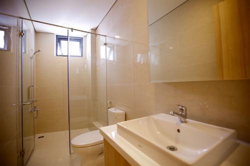 Spacious bathroom with a shower, and a large mirror