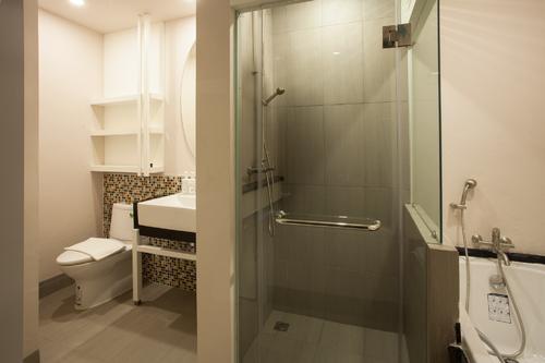 Large bathroom with a seperated toilet, and shower area