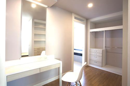 Large spacious walk-in closet including a work desk