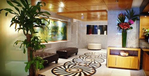 Lobby with reception, plants, and abstract art