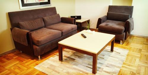 Livingroom with comfortable sofa, chair, and coffee table