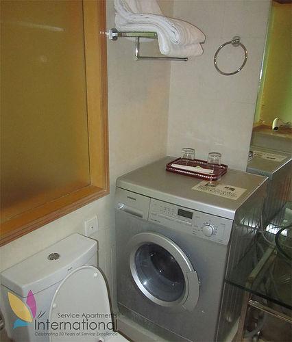 Bathroom with towels, and a gray washing machine