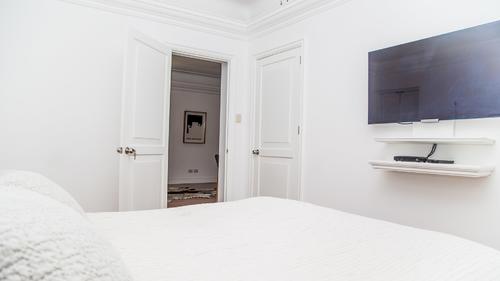 Bedroom with a large wall mounted TV